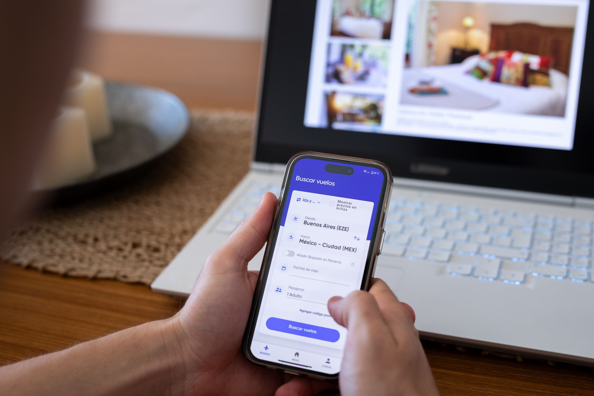 Unrecognizable person searching for flights using mobile phone